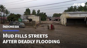 Homes and roads coated in mud after deadly floods hit Indonesia