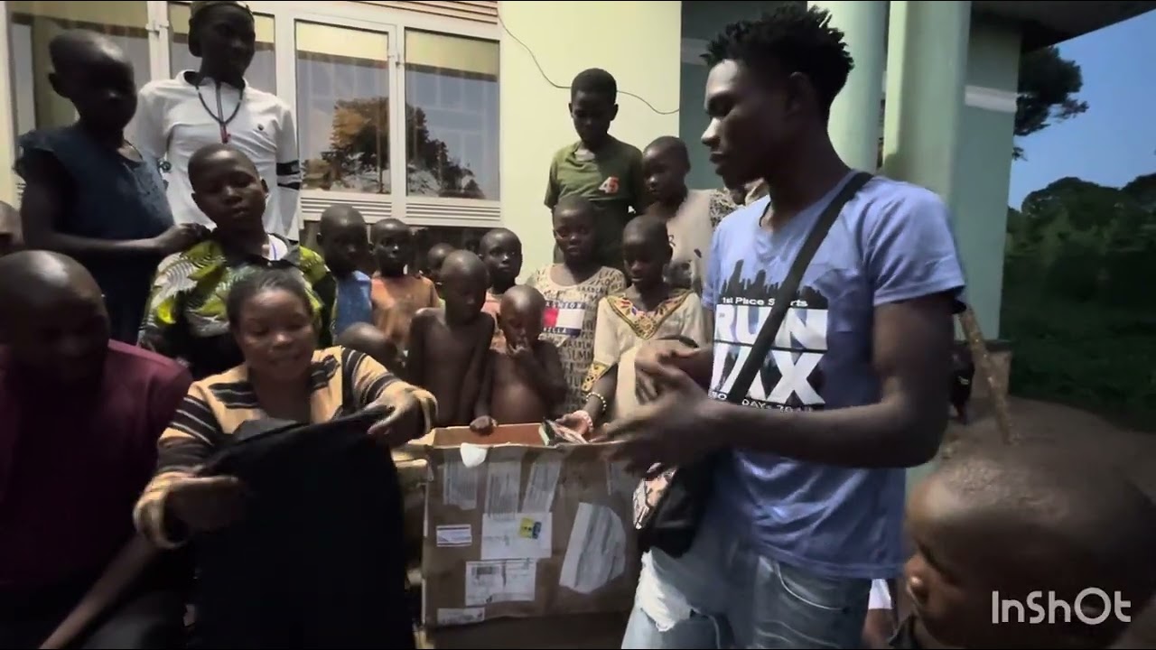 Mama Uganda and her children opening another two packages they received from USA 
