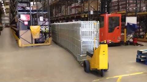 A MasterMover pushing Roll Cages throughout a Warehouse