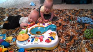 Twin babies playing together