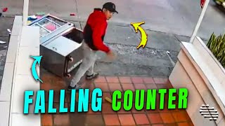 Display Counter Falls to the Ground as a Person Tries to Push It Outside