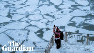 Polar vortex: 46C temperatures as Chicago River turns to ice