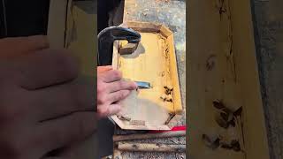 carving wooden tray with a sharp chisel tool to shape traditional handicraft in work table