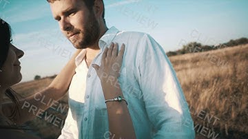 Happy Lovers hugging each other on field , slow motion