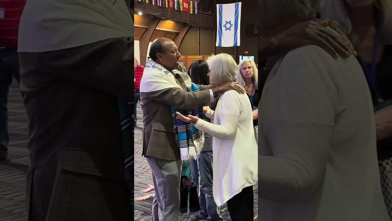 Encouraging words from Rabbi Kokeb Gedamu to Laurie Martin. “Glory of Israel” conference at Antioch.