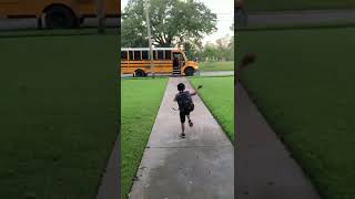 Little Boy Falls Onto Grass While Running to Catch School Bus Resimi