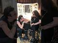 Yungblud gives a handmade cross to Ozzy Osbourne at the Back To The Beginning concert backstage
