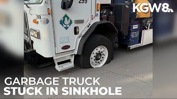 Garbage truck gets stuck in sinkhole in North Portland