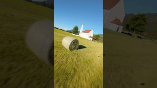 Flying FPV around a church in front of the Alps