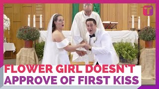 Flower Girl Doesn't Approve Of Couple's First Kiss On Altar