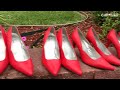 Men slip on red heels for a purpose
