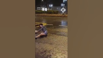 Woman violently thrown to ground by wind during Typhoon Saola in Hong Kong