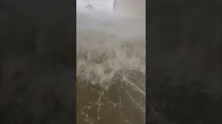 Person Filming Flooded Ground Level during a Hurricane