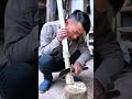 Carpenter hand planes wooden beam creating curling wood shavings