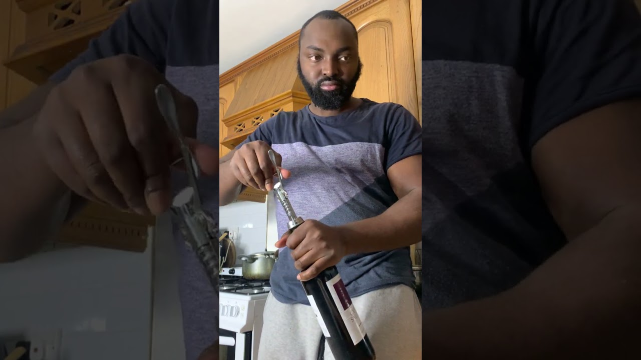 ‪How to open a bottle of wine using a winged corkscrew‬