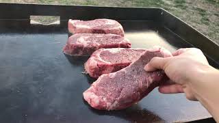 Ribeye steaks on the griddle with some veggies. great and fast way to
cook steaks!