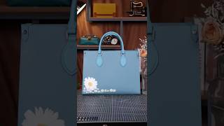 Hand-painted daisies on this bright blue leather bag. #handmadebag #bag #luxury #customize #america