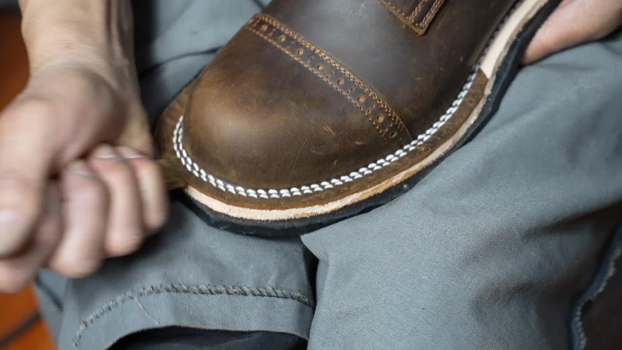 The process of making handmade work boots. Hands of craftsmen who make ...