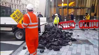 Climate Activists Dump Fake Coal Outside Insurance Company Headquarters in London