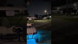 Guy standing on roof of golf cart rides on seated rope swing then hit back on rear of golf cart