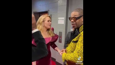 Thumbnail of Adele & Busta Rhymes giving each other their flowers at the Grammys