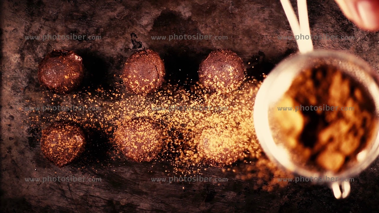 Sprinkle candy cocoa powder from a small spoon-sieve