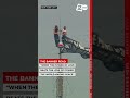2 people climb to top of Empire State Building, unfurl peace banner, and appear to get engaged