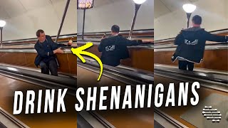 Drunk Man Going Down an Electric Escalator Winds up Falling and Spilling His Drink