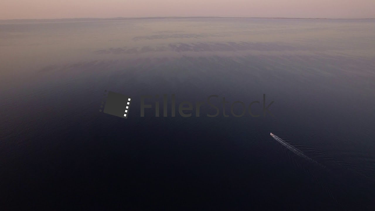 Vast water surface with sailing motor boat