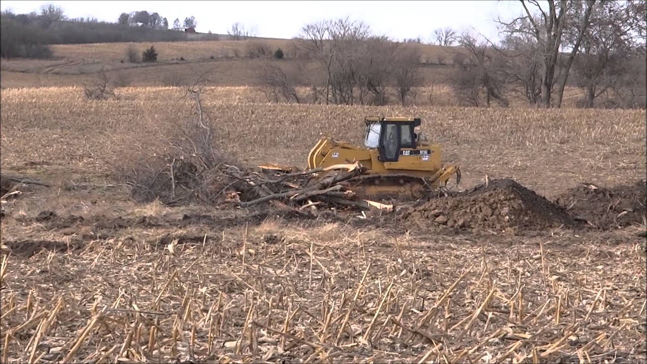 CAT 973C Crawler Loader pushing and stacking trees - YouTube