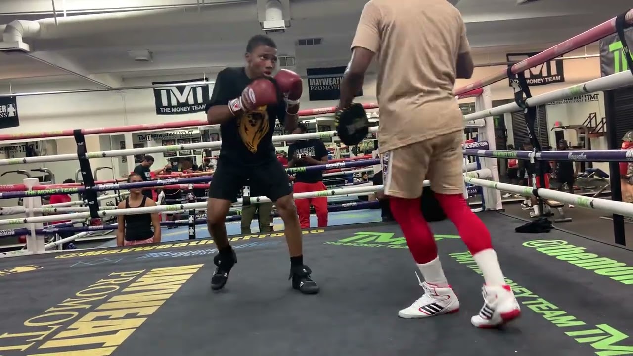 Floyd Mayweather Jr. giving King Robert Meriwether III a little mitt work