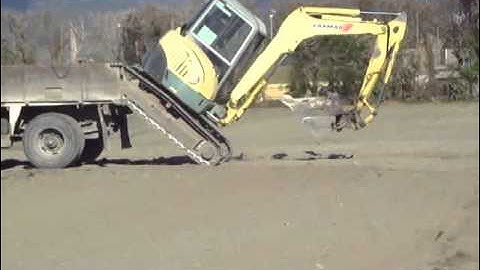 Loading an excavator onto a truck without ramps
