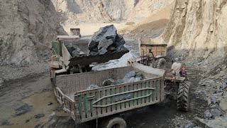 Massive Rock Loading Show by Powerful 966E Wheel Loader: Loading Huge Rocks into Big Trolleys