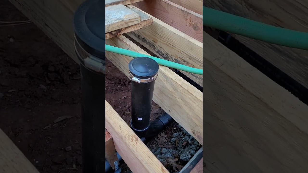 Underfloor framing and DWV pipe ready for building inspection.