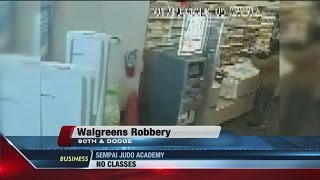 Surveillance video shows suspect rob Walgreens with rifle