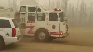 Raw: Syncrude trucks speeding towards Fort McMurray wildfire