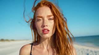 Beautiful Girl With Rusty Hair Walks On A Sunny Beach