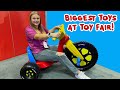 The Assistant Looks for the Biggest Toys at Toy Fair by Size