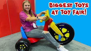 the assistant looks for the biggest toys at toy fair by size