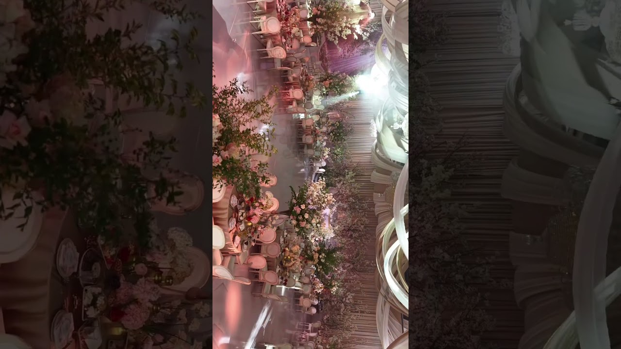 Ceiling drape and rigged floral installation above a wedding stage in a Kuala Lumpur ballroom