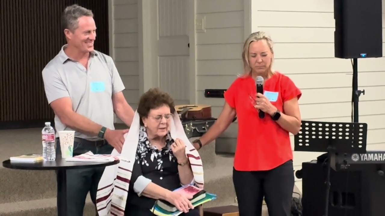 Prayer for Sharon Sanders under the talitt at the Camp Barkeley Fellowship meeting in Abilene, TX