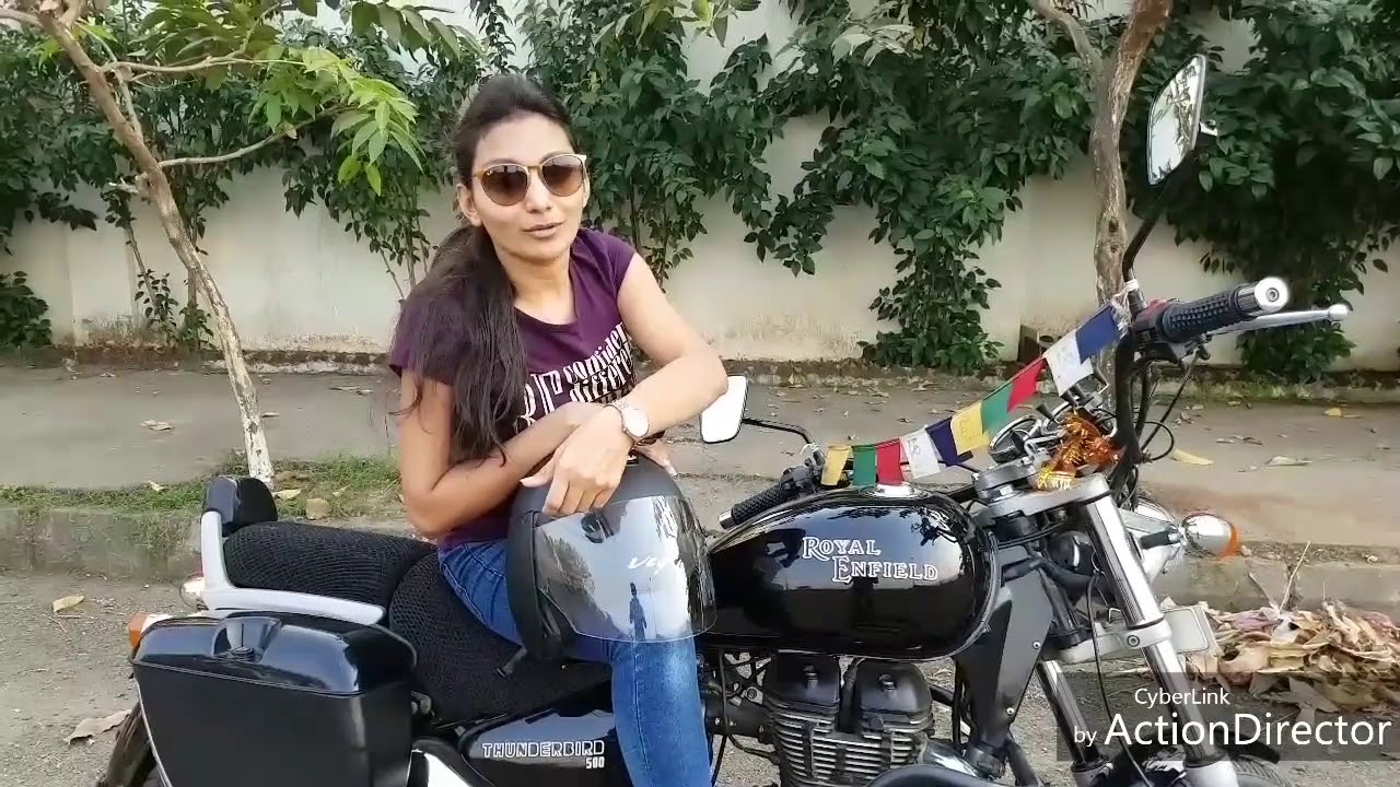 girl driving royal enfield