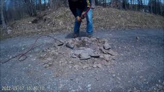 Removing the top of a boulder in a driveway using a torch