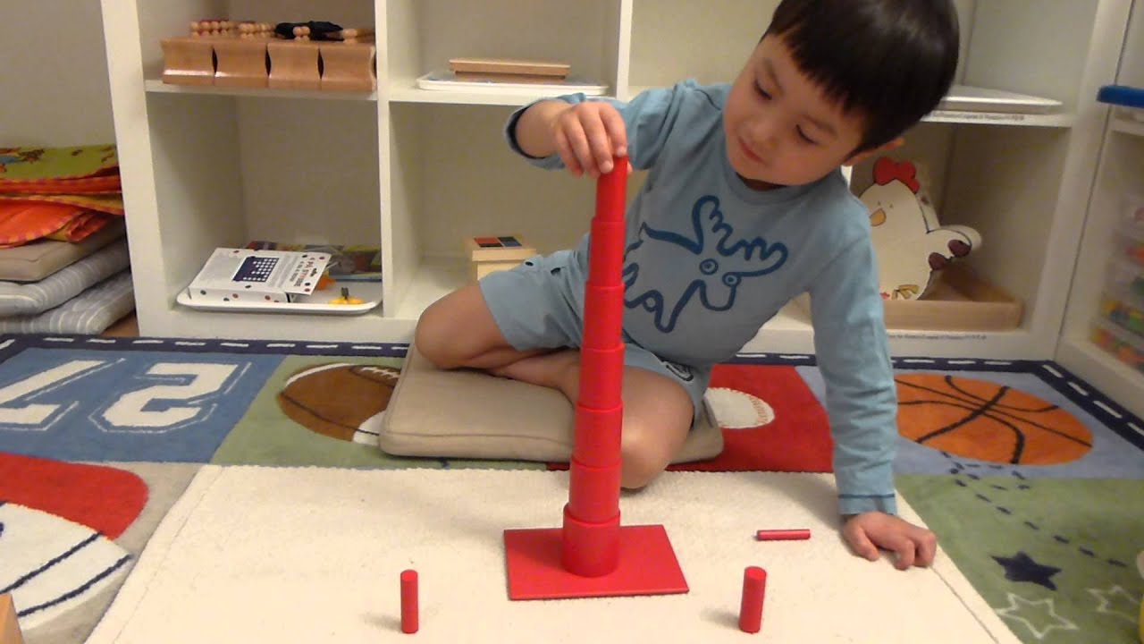 J working with the Montessori red knobless cylinders - YouTube