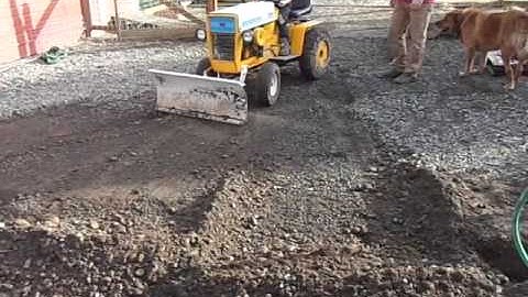 Granpa teaching grandkids to move dirt with a cub cadet 123