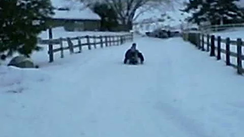 Colin Snyder sledding in his driveway