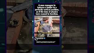 A man manages to balance a ladder in a perfectly vertical position, as if the la...