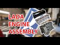 Two rookie mechanics assemble a Lada engine