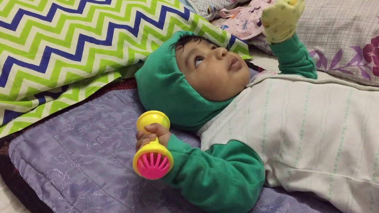 Baby holding toy baby milestone YouTube