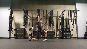 Half kneeling single arm overhead dumbbell tricep extension